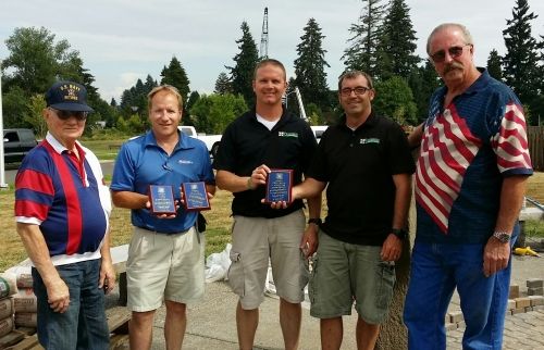 Preferred Landscape Services team members standing with veterans during the Veterans Foreign Wars memorial project
